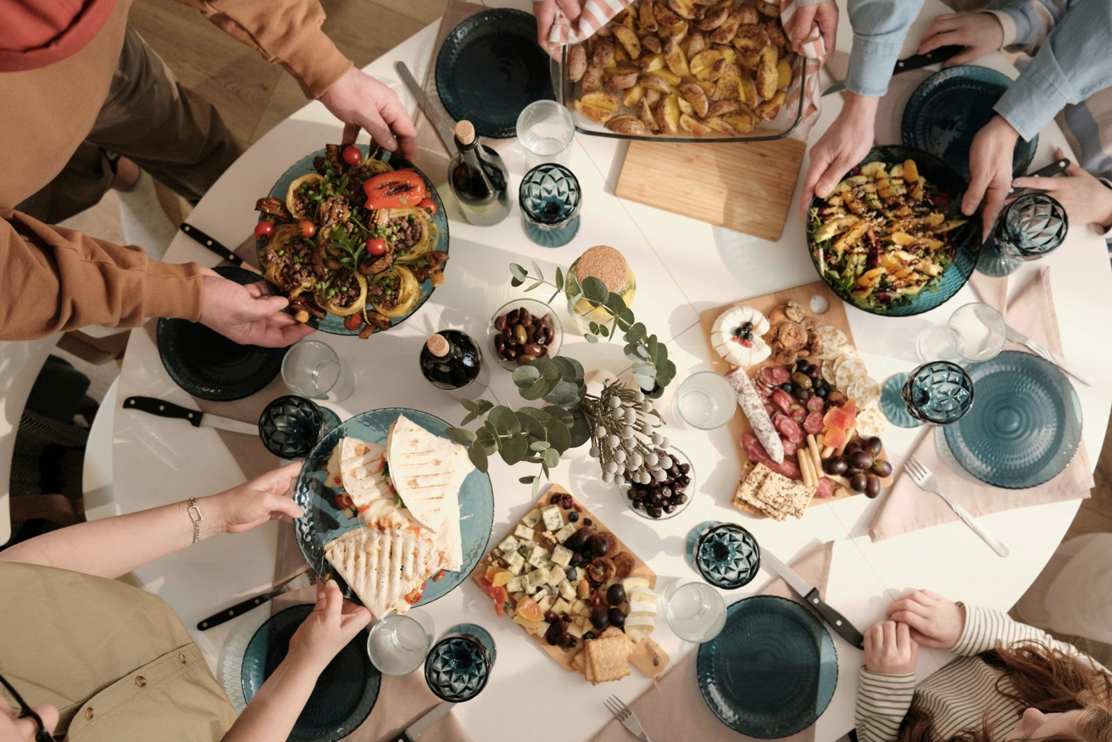 Friends sharing plates of food around a table
