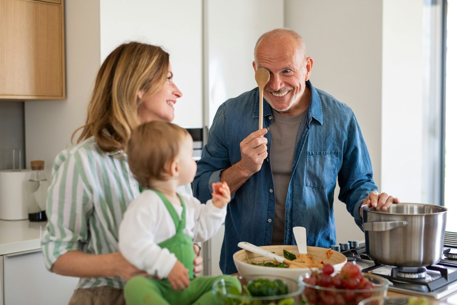 Three generations cooking together in a bright kitchen